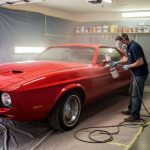 Car being painted in home garage showing affordable DIY paint application technique