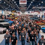 Rows of custom-built vehicles on display inside the Las Vegas Convention Center during SEMA Show 2026, with hundreds of attendees walking the show floor