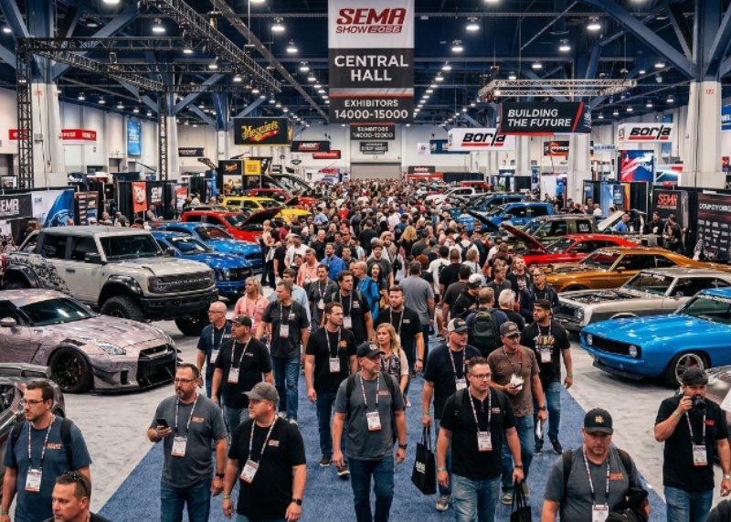 Rows of custom-built vehicles on display inside the Las Vegas Convention Center during SEMA Show 2026, with hundreds of attendees walking the show floor