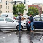 Driver reviewing delayed insurance claim documents after a car accident