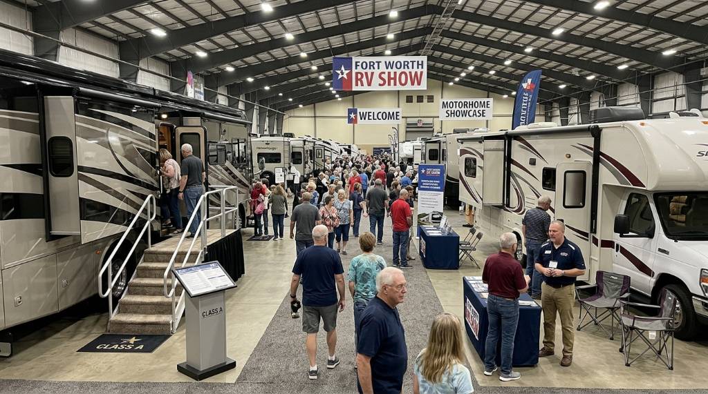 Visitors exploring Class A and Class C motorhomes at an indoor RV show exhibit in Fort Worth